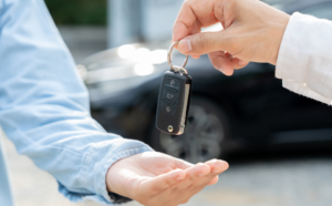 Handing over a rental car key.