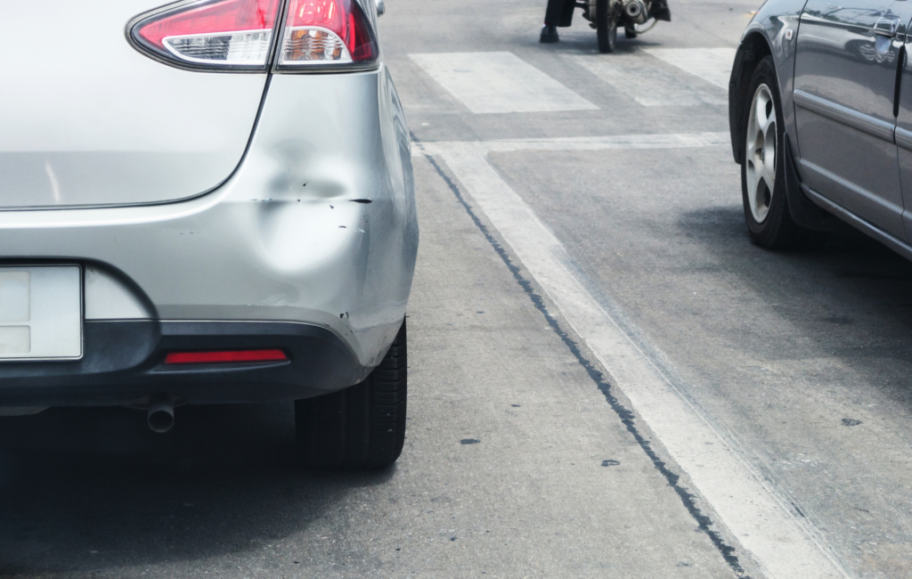 Dented bumper showing the damage from a car accident during the holidays.