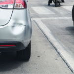 Dented bumper showing the damage from a car accident during the holidays.