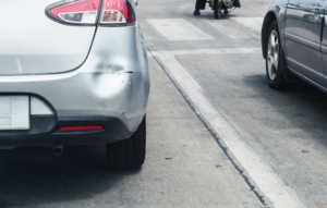 Dented bumper showing the damage from a car accident during the holidays.