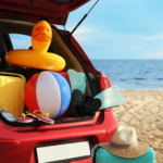 Car at beach packed with essentials, including an emergency kit in case of a car accident.