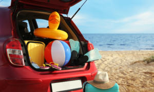 Car at beach packed with essentials, including an emergency kit in case of a car accident.